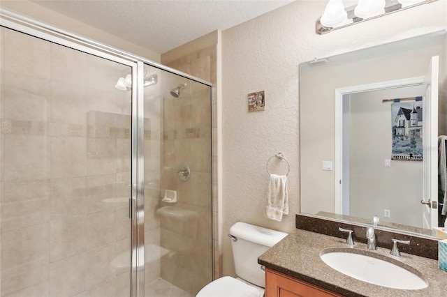 bathroom with vanity, a textured ceiling, toilet, and an enclosed shower