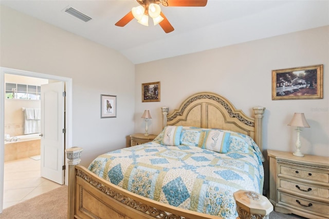 carpeted bedroom featuring ensuite bath, vaulted ceiling, and ceiling fan