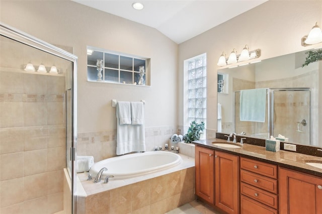 bathroom featuring vanity, lofted ceiling, and plus walk in shower