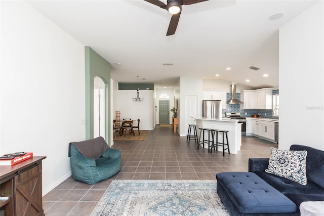 living room featuring dark tile patterned flooring and ceiling fan