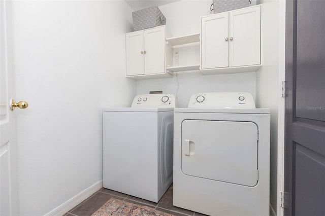 washroom with washer and dryer and cabinets