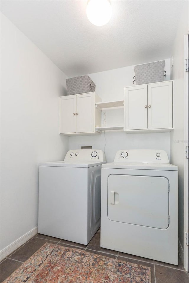 clothes washing area featuring cabinets and washing machine and dryer