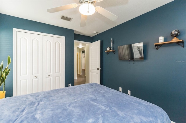 bedroom with ceiling fan and a closet