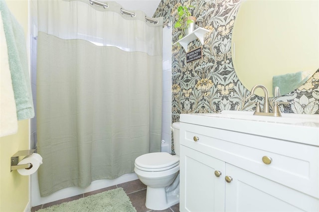 bathroom with tile patterned flooring, vanity, toilet, and walk in shower