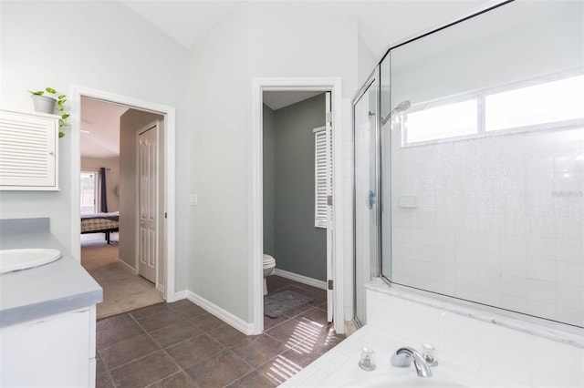 full bathroom with vanity, separate shower and tub, and toilet