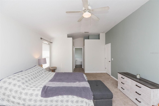 bedroom with light colored carpet, ceiling fan, and ensuite bathroom