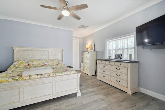 bedroom featuring ceiling fan, crown molding, and wood-type flooring