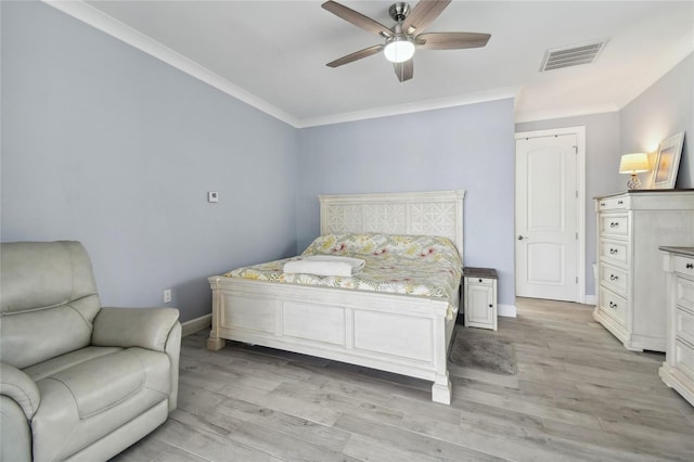 bedroom with ornamental molding, light wood-type flooring, and ceiling fan