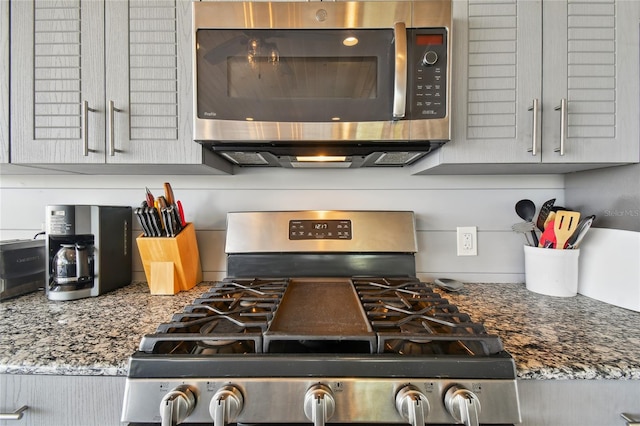 kitchen featuring appliances with stainless steel finishes and dark stone countertops