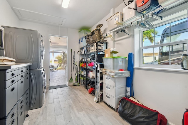 interior space with light hardwood / wood-style floors and stacked washing maching and dryer