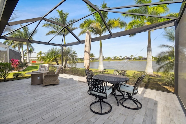 wooden deck featuring a water view and a lanai