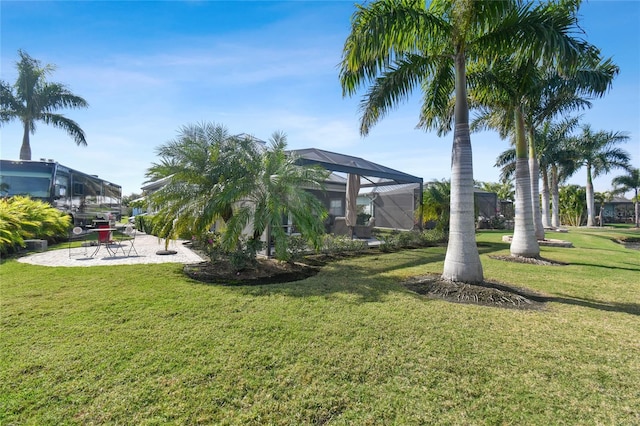 view of yard featuring a lanai and a patio