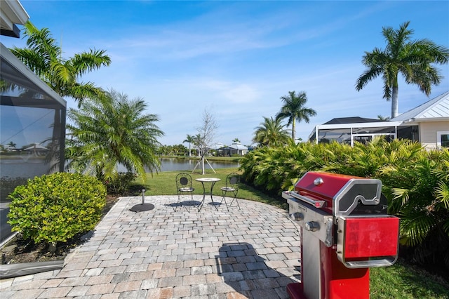 view of patio featuring a water view and grilling area