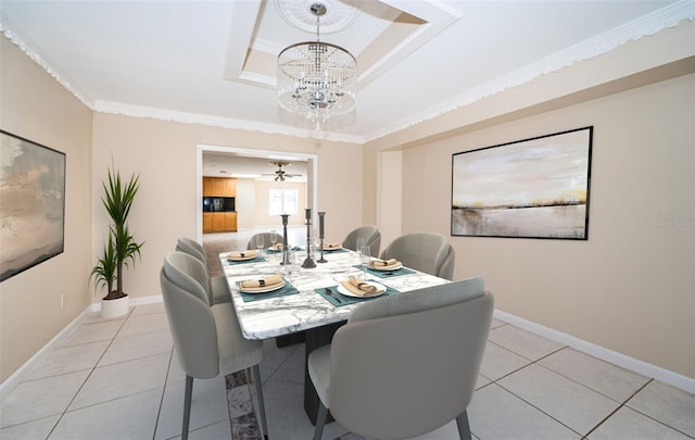 tiled dining area with a notable chandelier, a tray ceiling, and crown molding