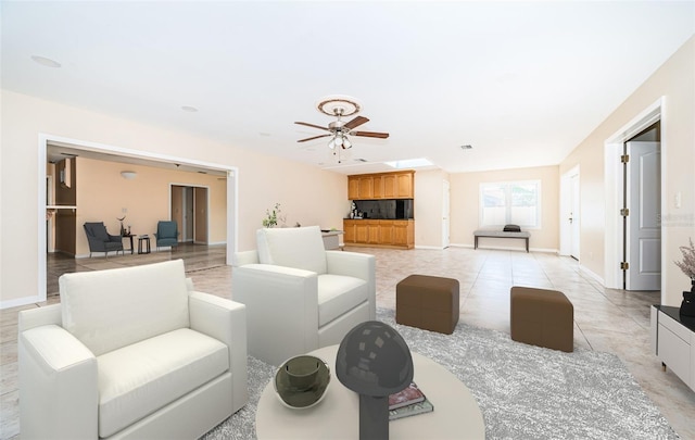 living room with light tile patterned floors and ceiling fan