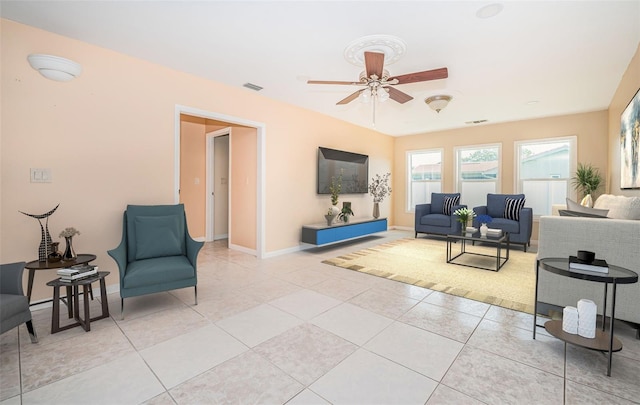 living room with ceiling fan and light tile patterned floors