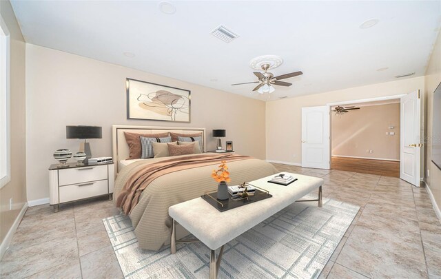 tiled bedroom with ceiling fan