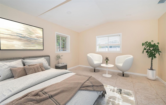 bedroom with lofted ceiling and light tile patterned flooring