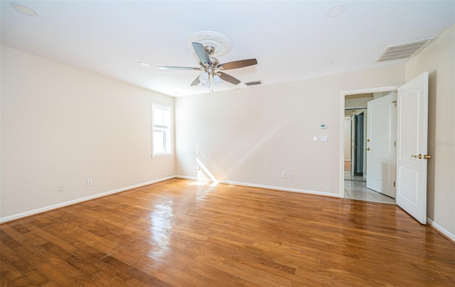 unfurnished room with light wood-type flooring and ceiling fan