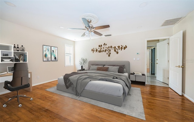 bedroom featuring hardwood / wood-style floors and ceiling fan