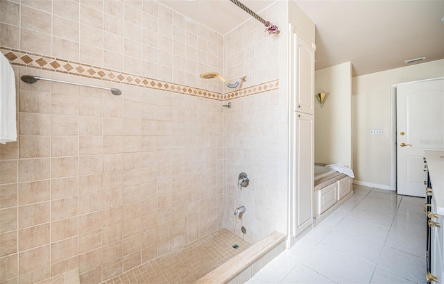 bathroom featuring a tile shower and tile patterned flooring