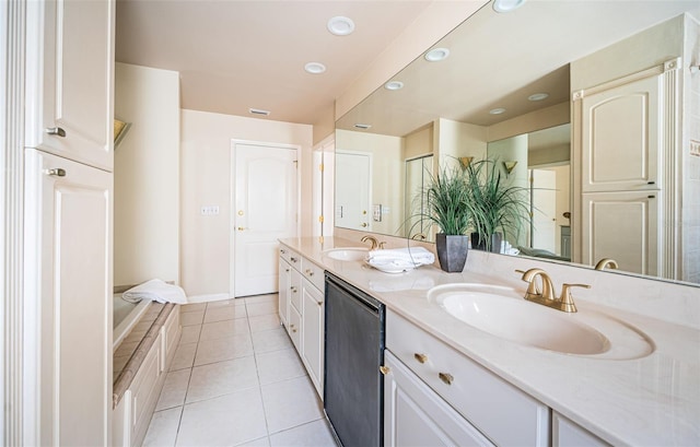 bathroom with tile patterned flooring, tiled tub, and vanity