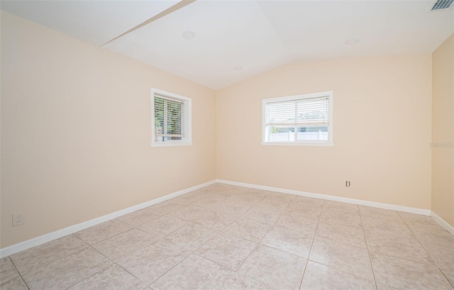 tiled empty room with vaulted ceiling