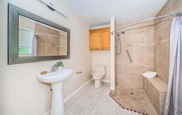 bathroom with walk in shower, tile patterned flooring, and toilet