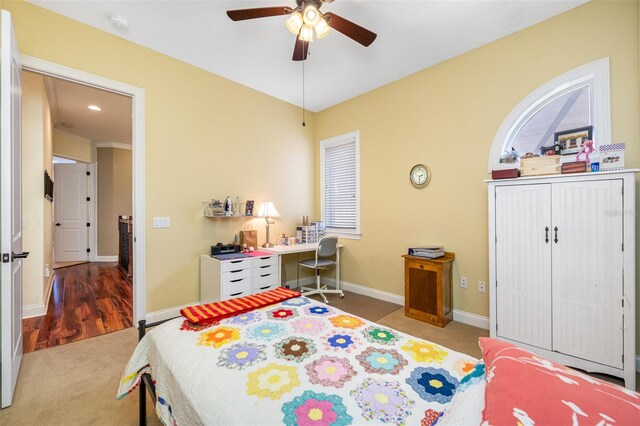 bedroom featuring carpet floors, crown molding, and ceiling fan