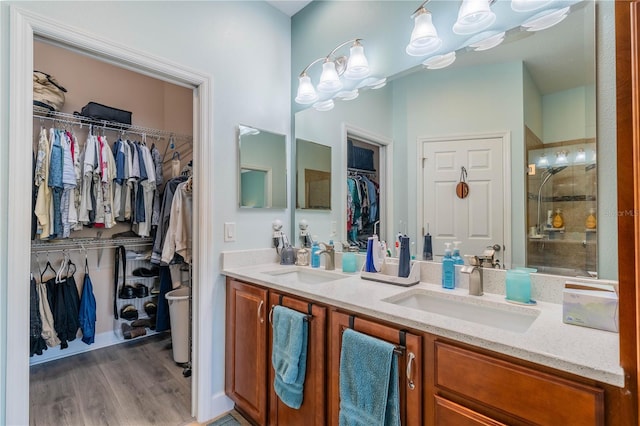 bathroom featuring wood-type flooring, vanity, and an enclosed shower