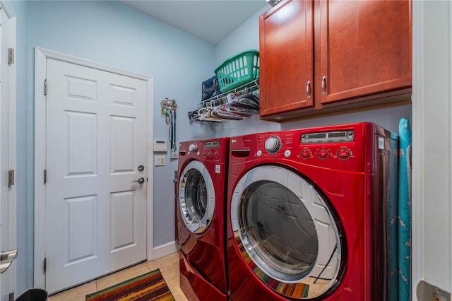 clothes washing area featuring cabinets, independent washer and dryer, and light tile patterned floors