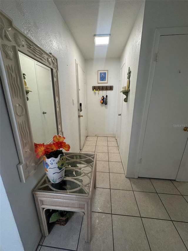 corridor with light tile patterned floors