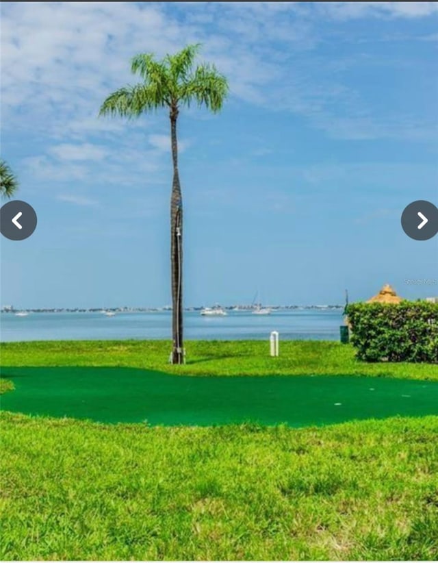 surrounding community featuring a water view and a yard