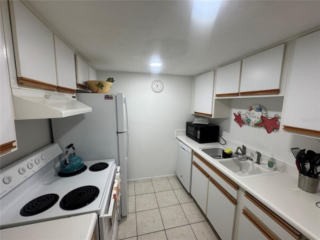 kitchen featuring white appliances, ventilation hood, light tile patterned flooring, a sink, and white cabinetry