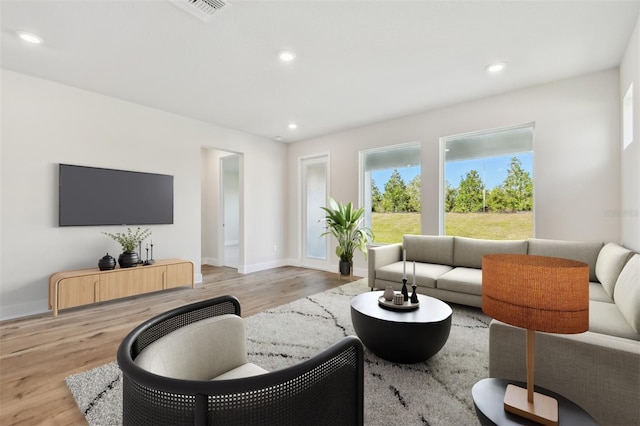 living area with recessed lighting, light wood-type flooring, and visible vents