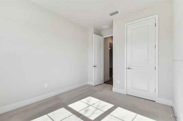 unfurnished bedroom featuring light carpet, baseboards, and visible vents