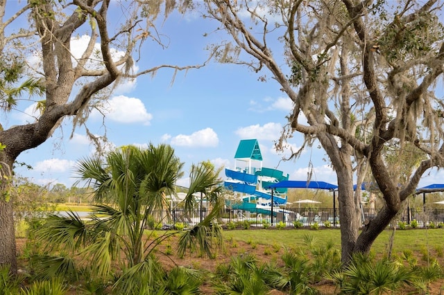 view of property's community featuring fence and playground community