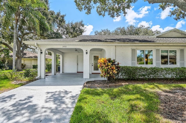 single story home with a front lawn and a carport