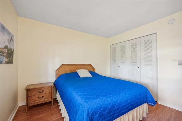 bedroom with hardwood / wood-style floors and a closet