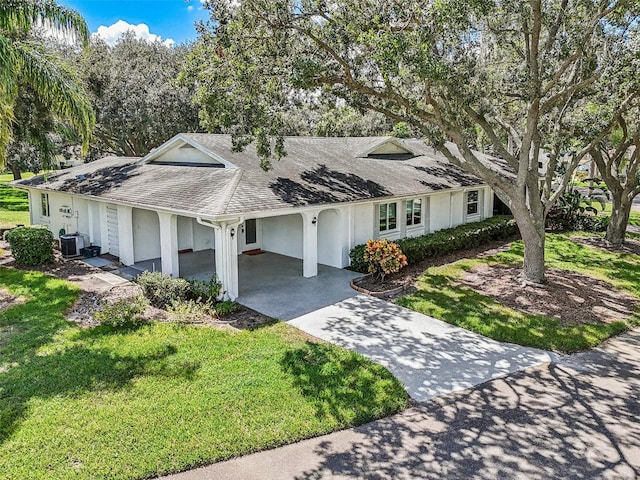 ranch-style house with a front yard and cooling unit