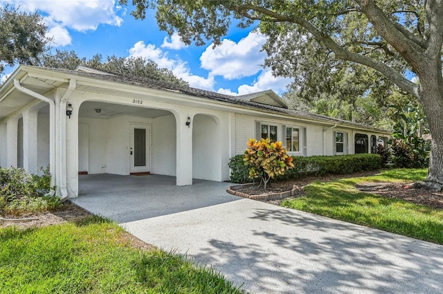 ranch-style home with a carport