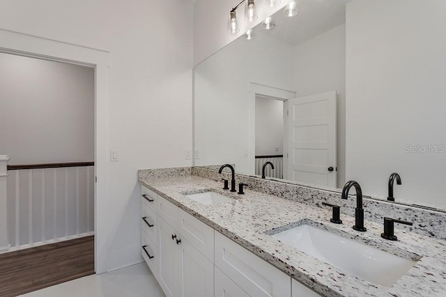 bathroom with hardwood / wood-style floors and vanity