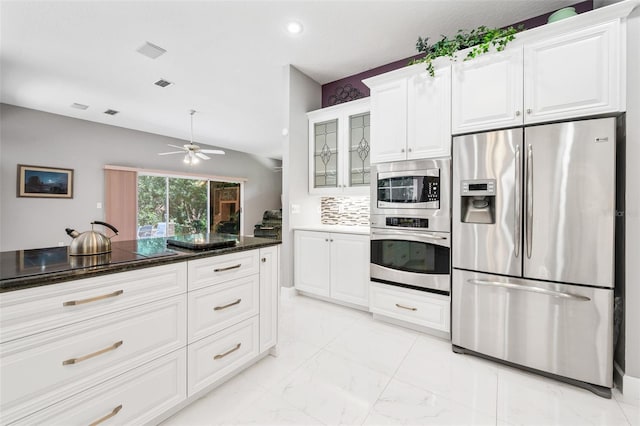 kitchen with ceiling fan, tasteful backsplash, dark stone countertops, white cabinets, and appliances with stainless steel finishes