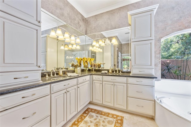 bathroom with vanity, ornamental molding, and a tub to relax in