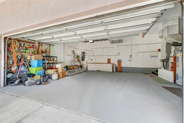 garage with electric water heater and a garage door opener