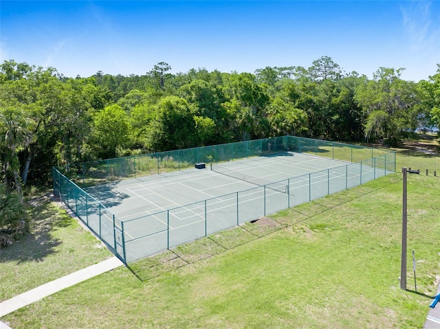 view of sport court with a lawn