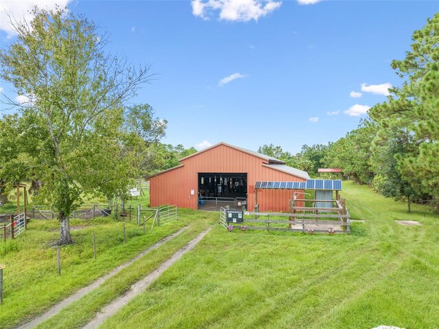 view of yard with a rural view and an outdoor structure