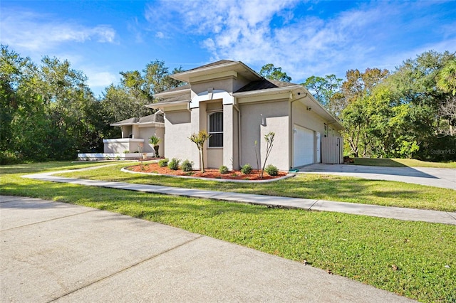 view of front facade with a front yard and a garage