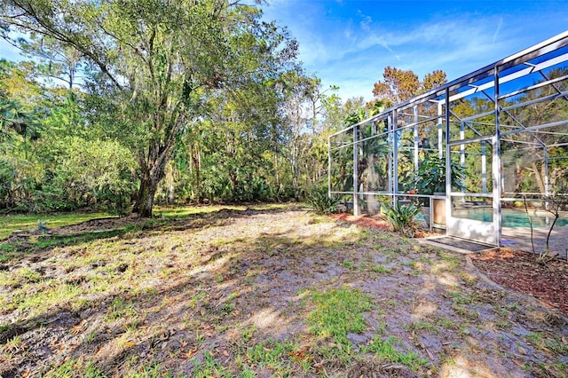 view of yard with glass enclosure