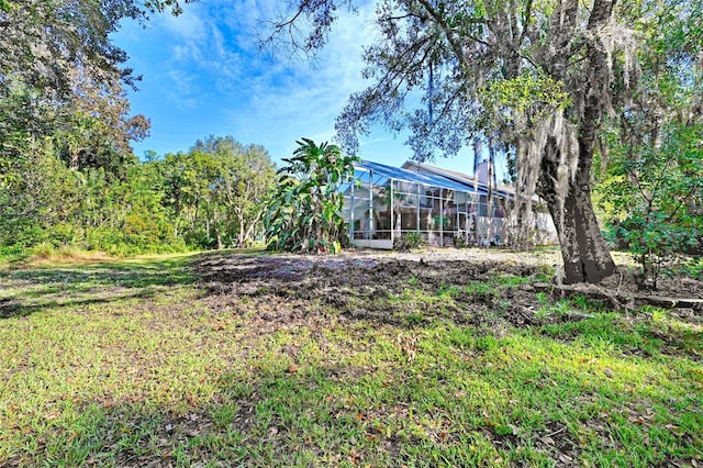 view of yard featuring glass enclosure